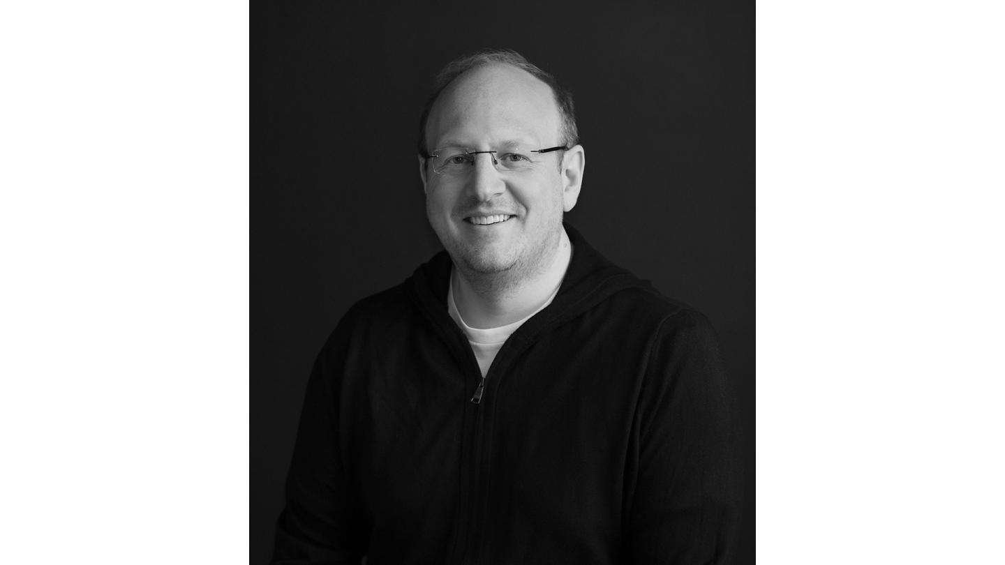 Black and white headshot of composer Kerry Muzzey.