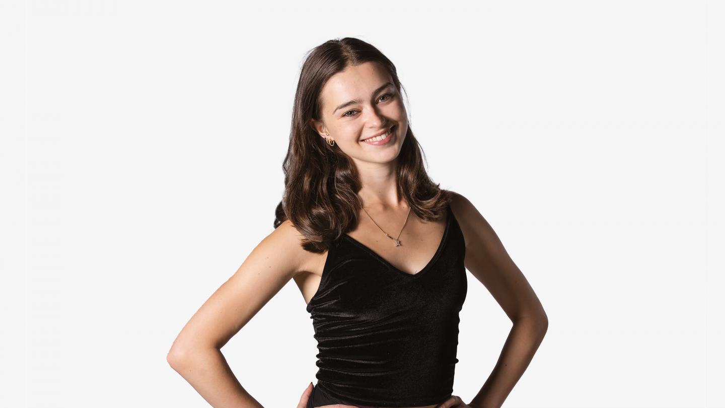 Headshot of female dancer with dark hair in a black top