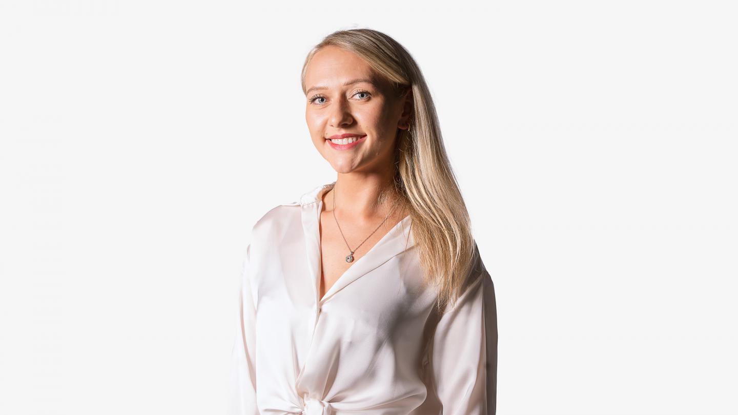 Headshot of a female dancer in a white shirt