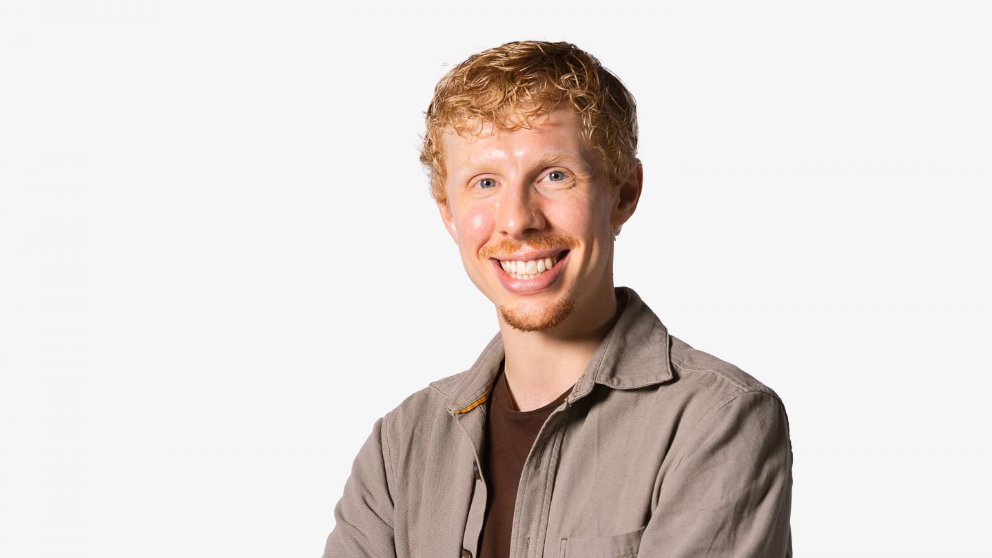 Headshot of a male dancer in a grey shirt