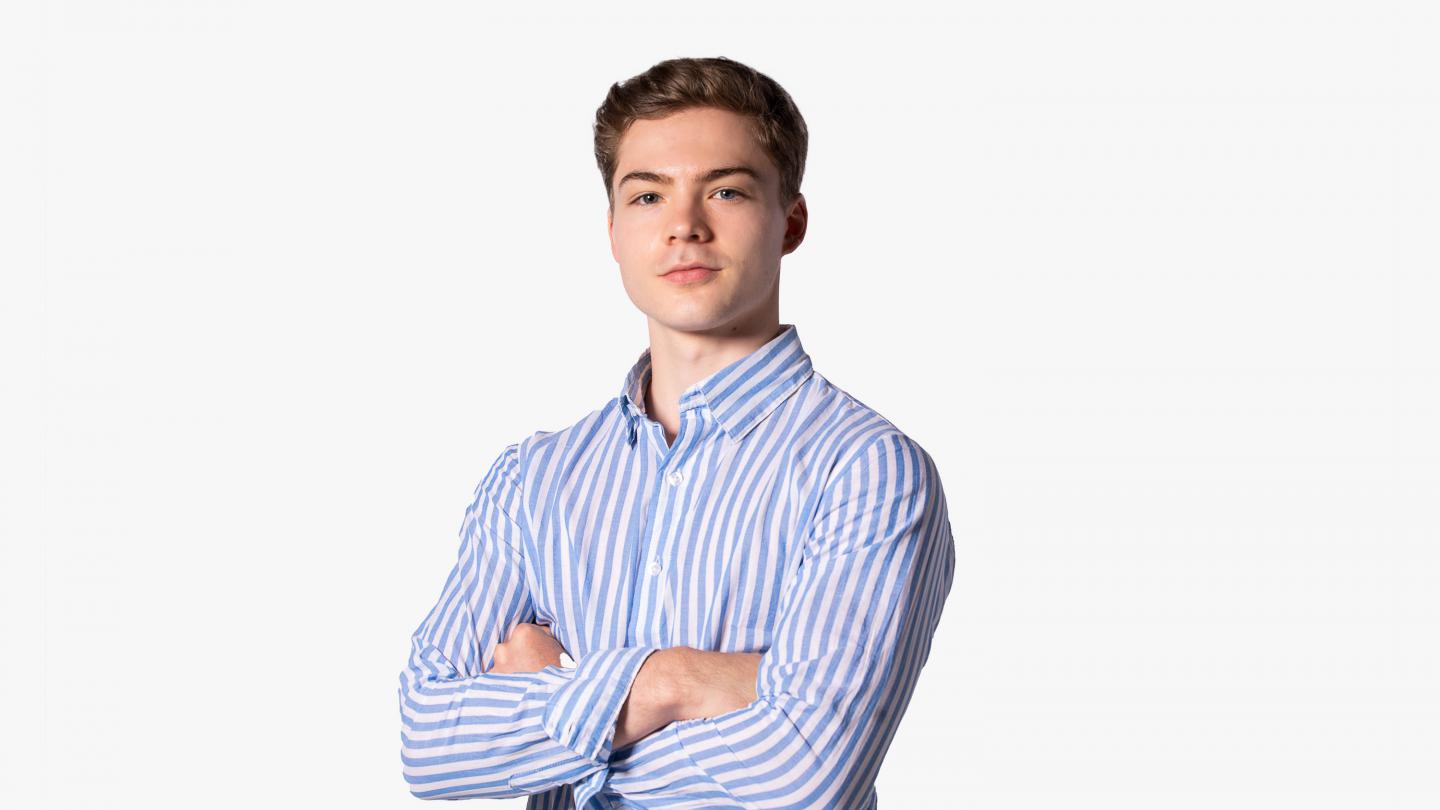 Headshot of a male dancer in a blue striped shirt