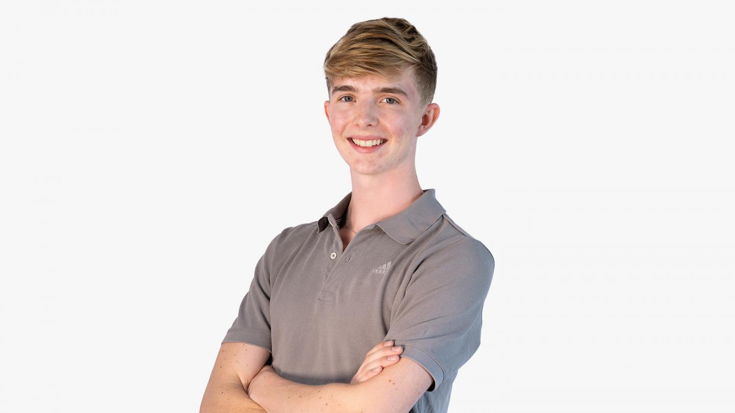 Headshot of a male dancer in grey polo shirt