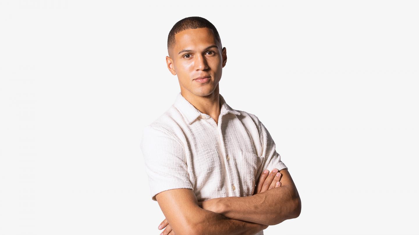 A headshot of a male dancer in white polo shirt