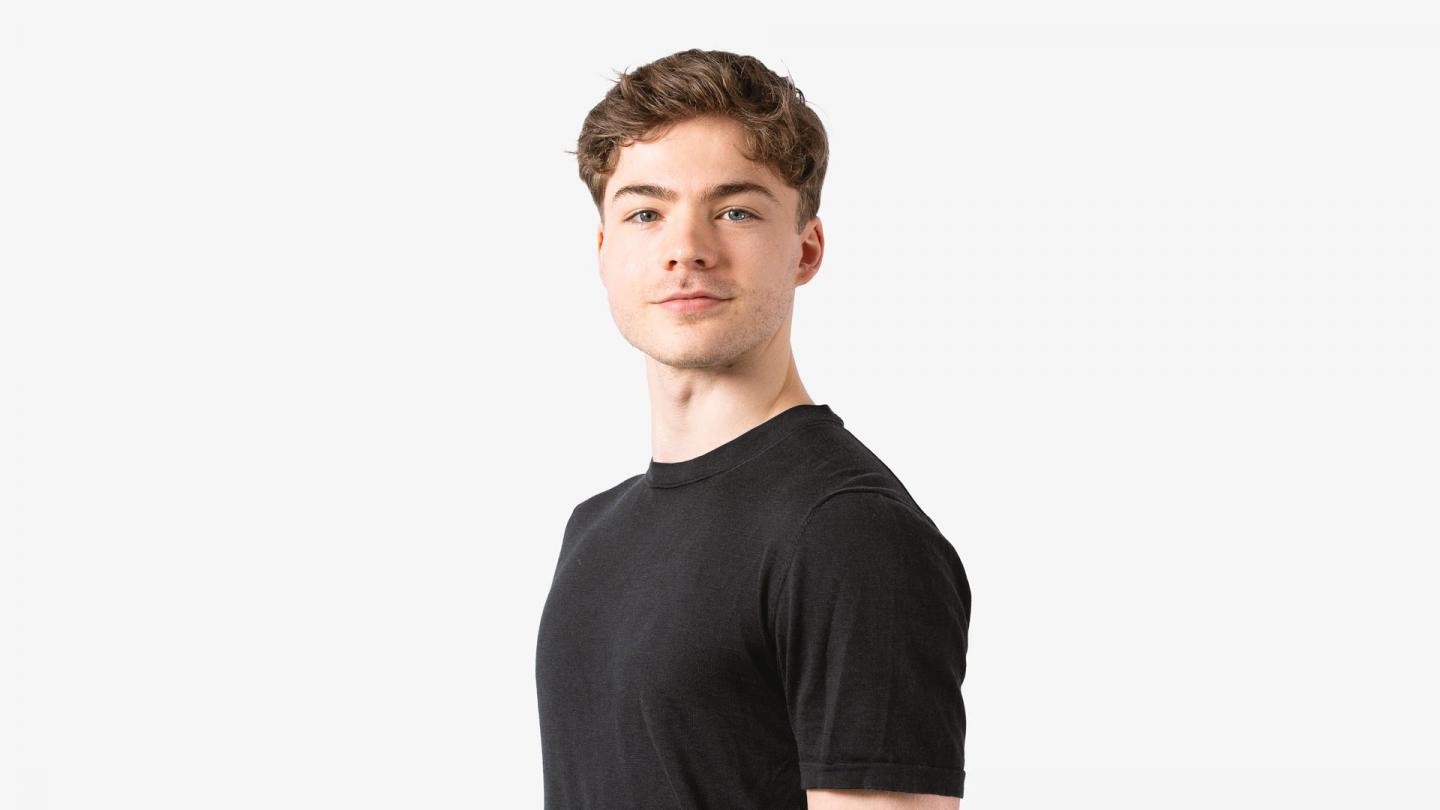 A headshot of a man looking forward in a black t shirt