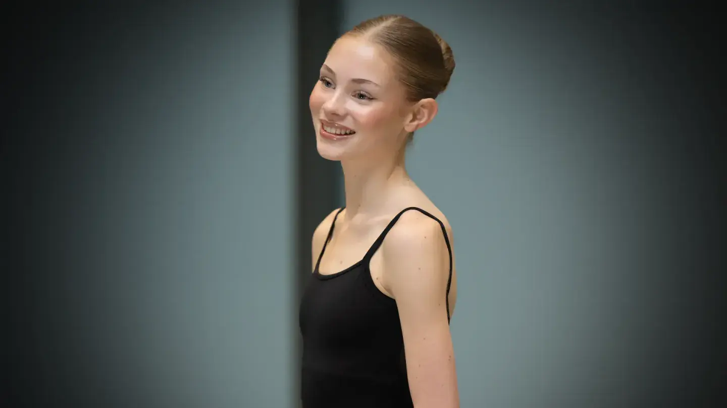 Woman in black wearing a black leotard