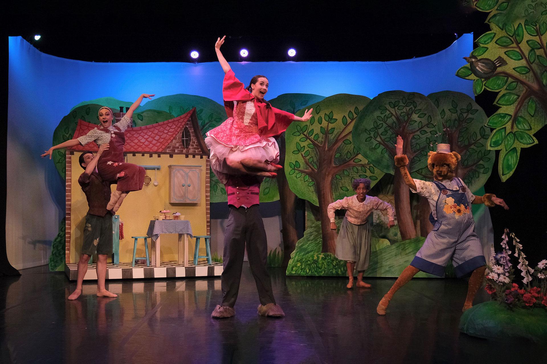 Everyone dances happily outside Little Red's home