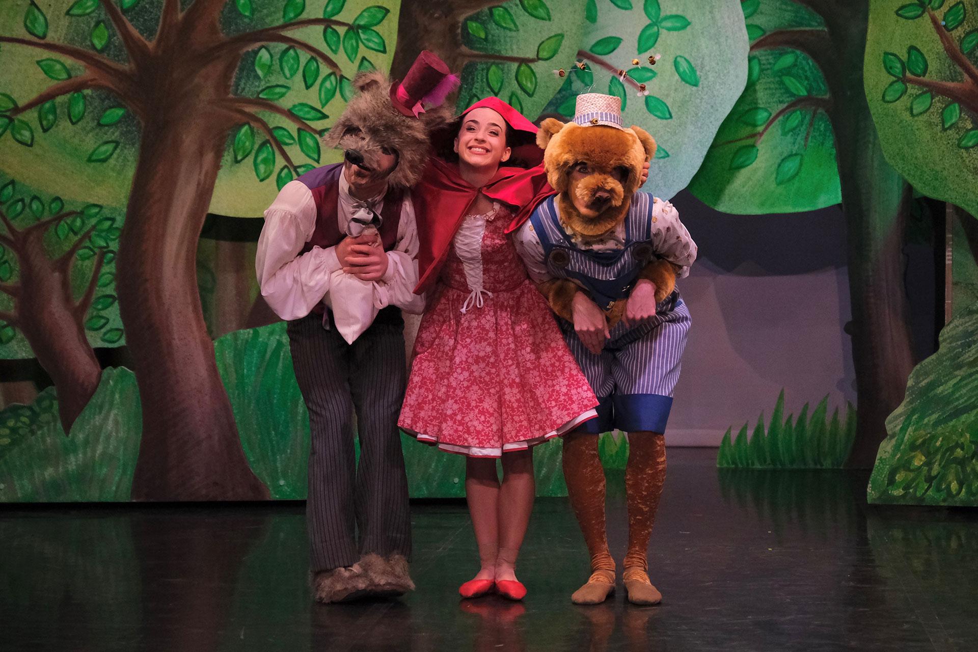 Little Red hugs Wolf and Bear after BEar agrees to sell Wolf some of his honey