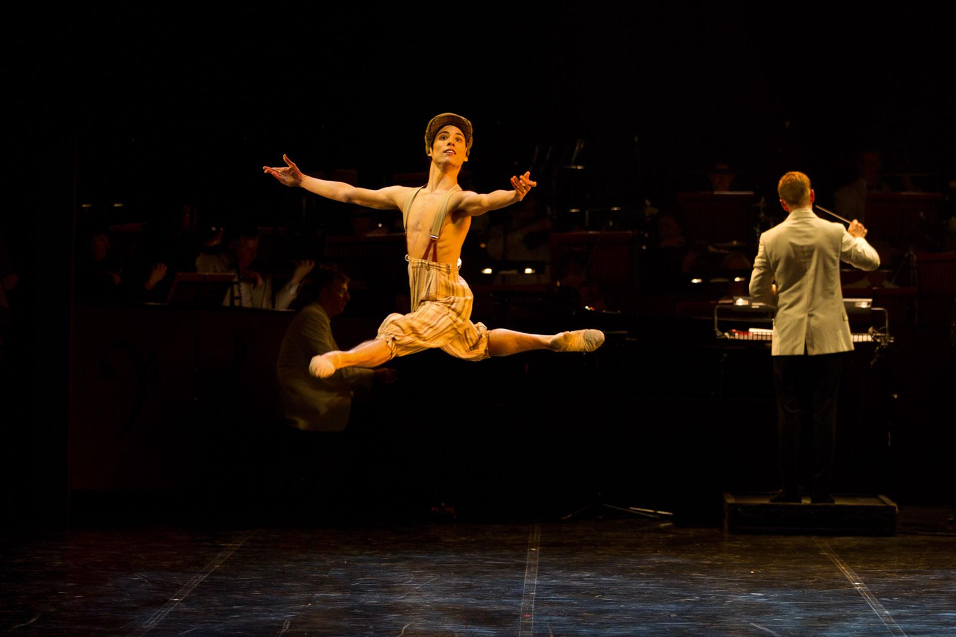 I Got Rhythm, production, 2012, Kevin Poeung, photo Emma Kauldhar Jumping high wearing only trousers, Kevin Peoung jumps, open arms, to the audience