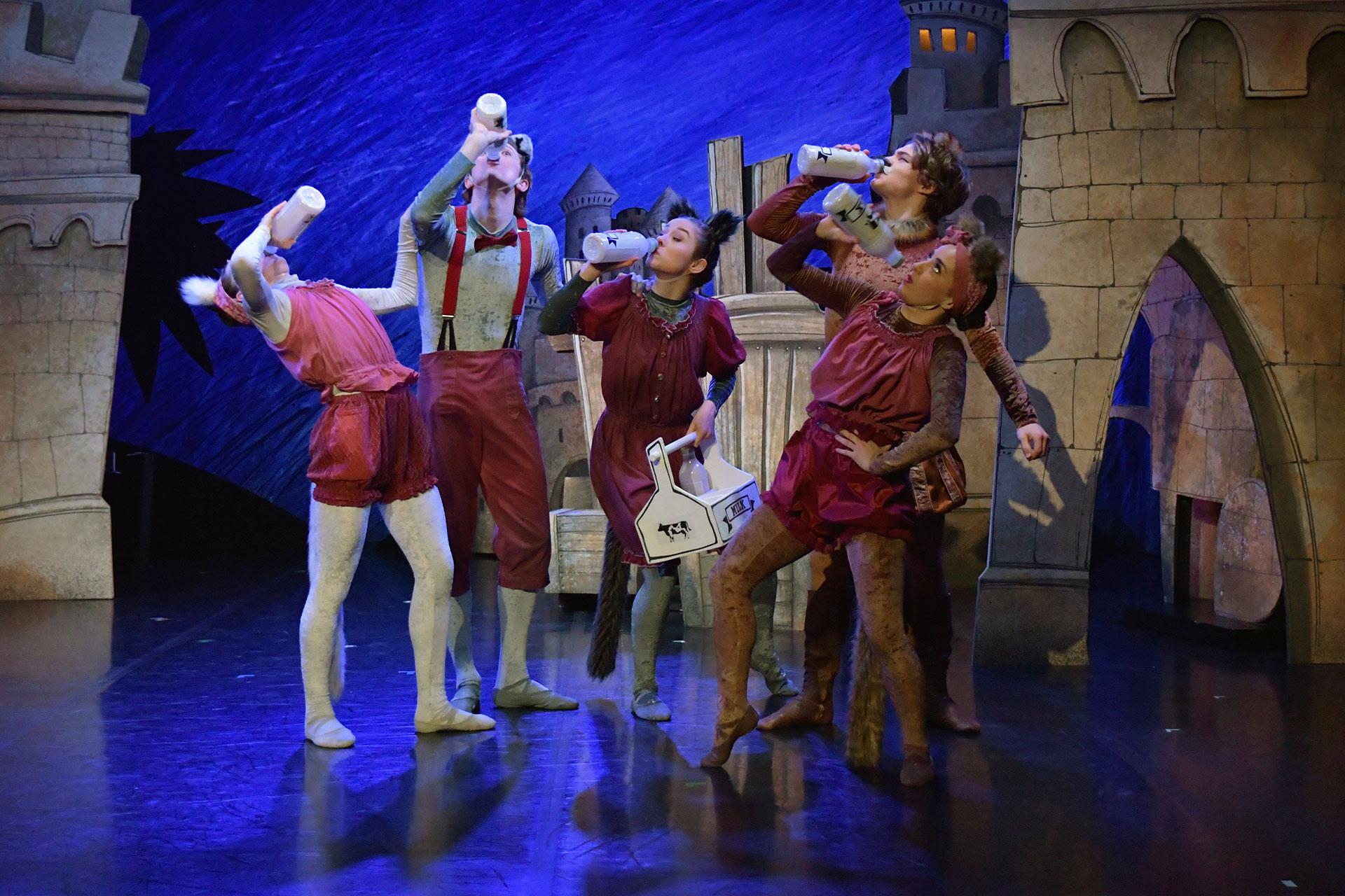 The village cats hang on street corners drinking milk