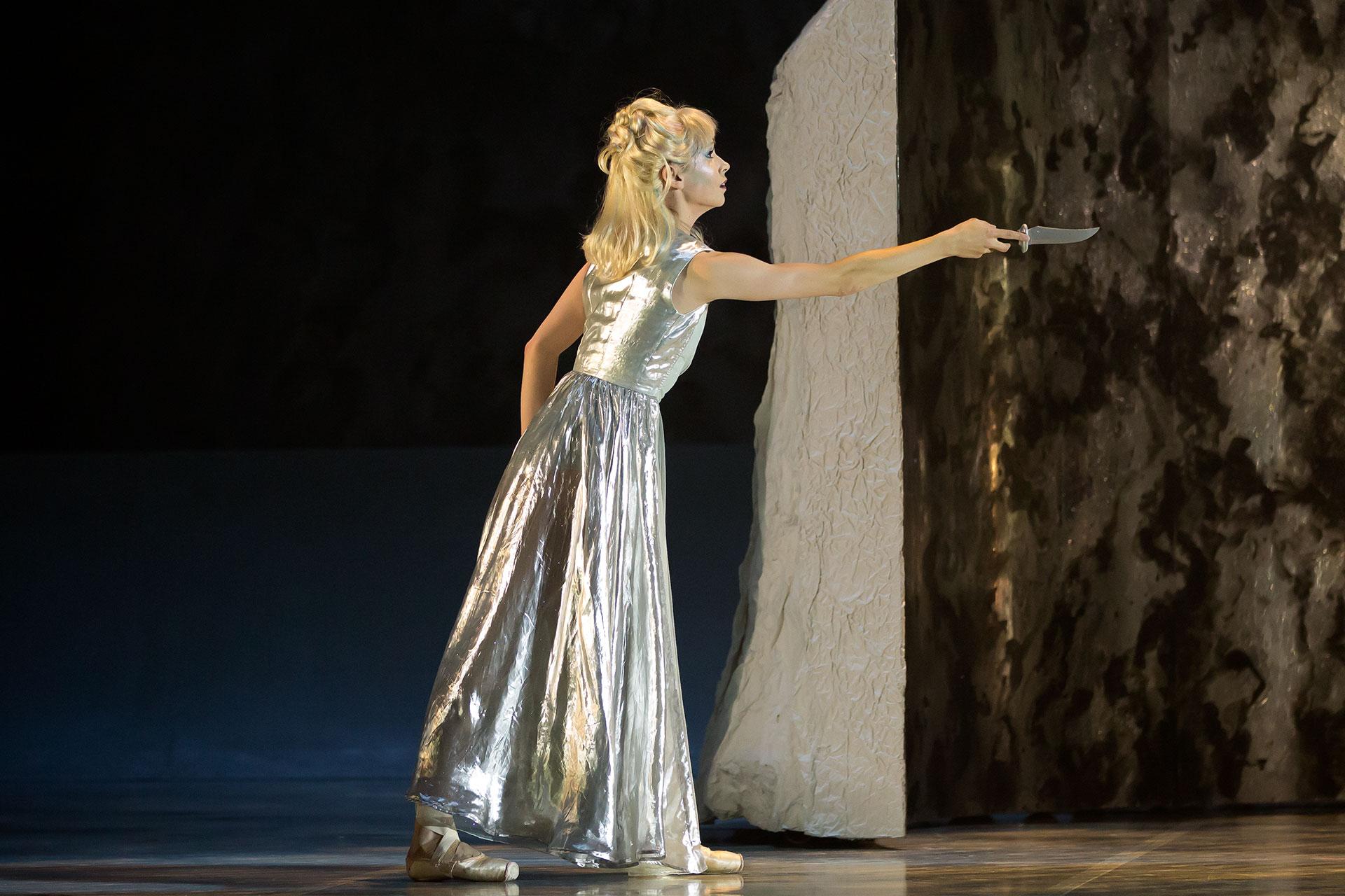 Marilla holds a knife in front of her uncertainly