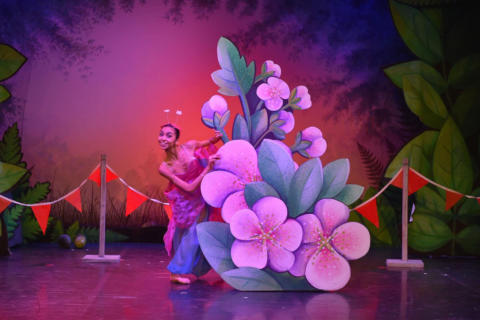 The beautiful butterfly emerges from behind some delicate flowers