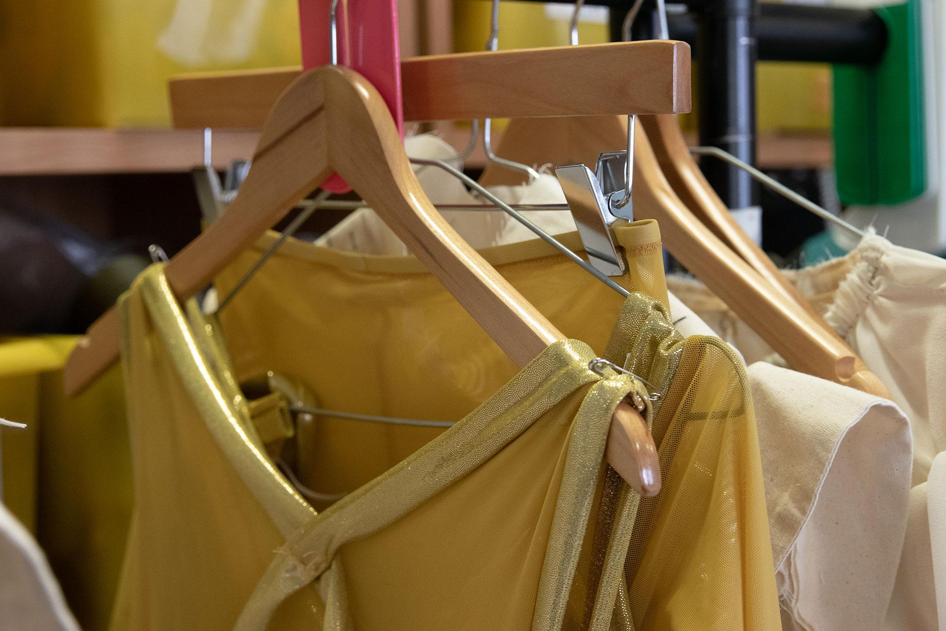 A selection of golden costumes from Merlin on the rack