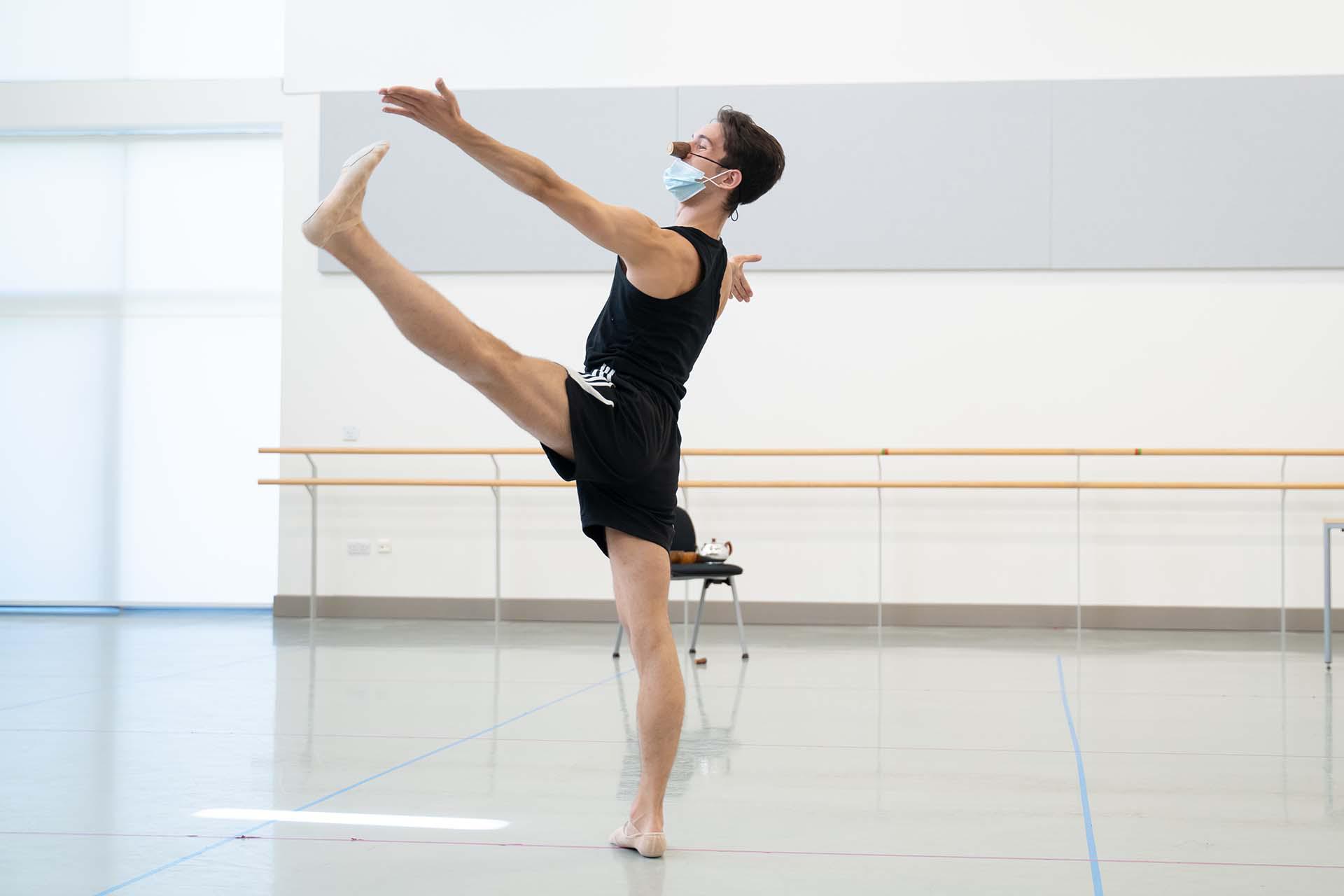 With his nose growing, a dancer strides across the rehearsal room