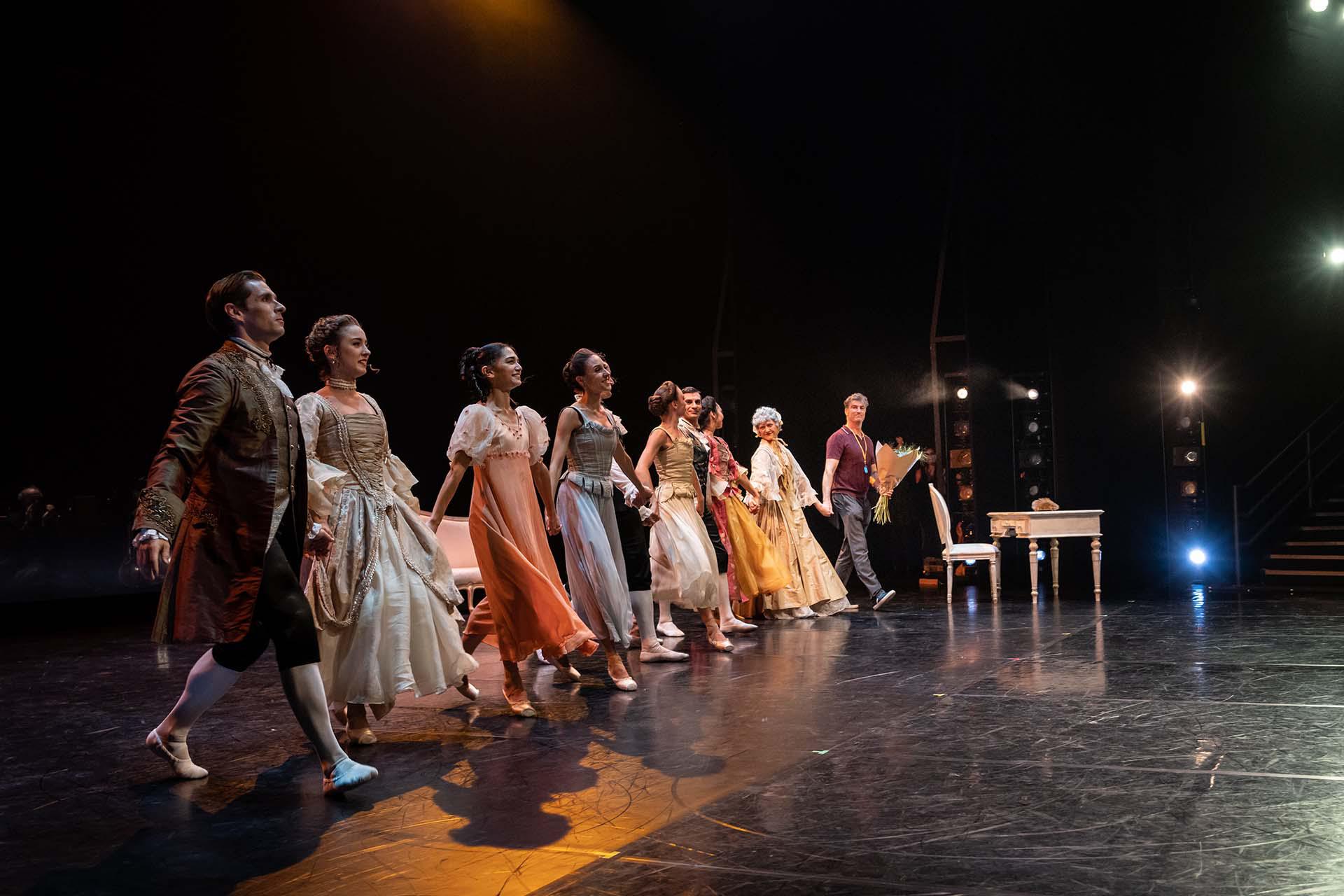 David holds a bouquet of flowers and joins in with the dancers giving a curtain call