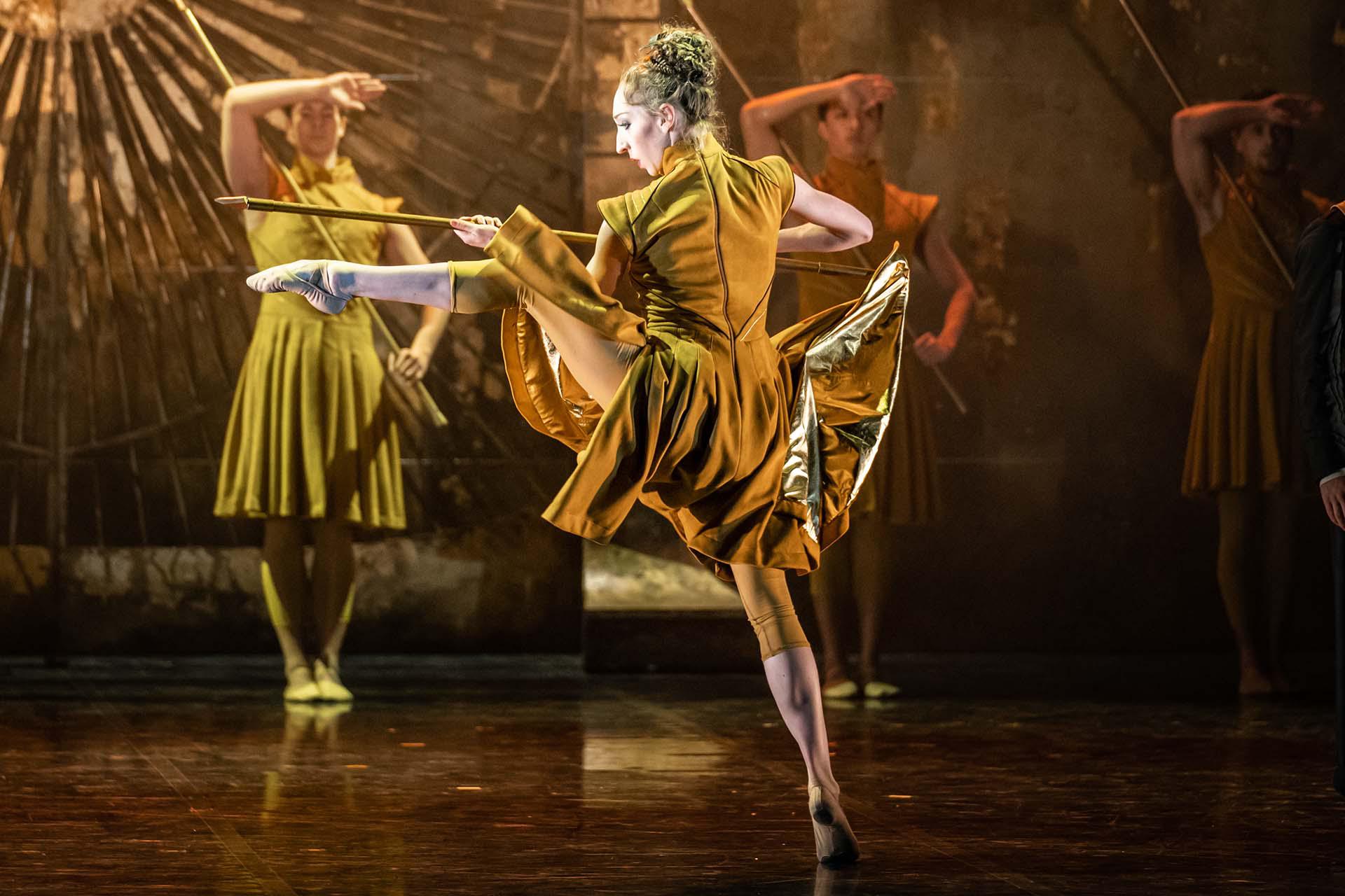 Merlin, production, 2021, Heather Lehan as the Blacksmith. Photo Riku Ito The blacksmith, now in the army, menacingly holds a pike