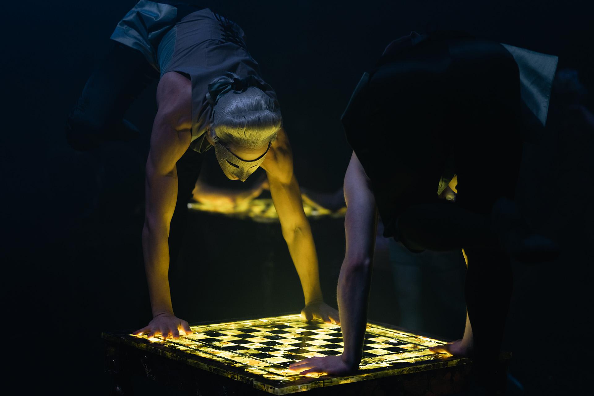 Casanova, production, 2022, Northern Ballet dancers, photo Riku Ito Dancers in masks illuminated by gaming tables they are leaning against