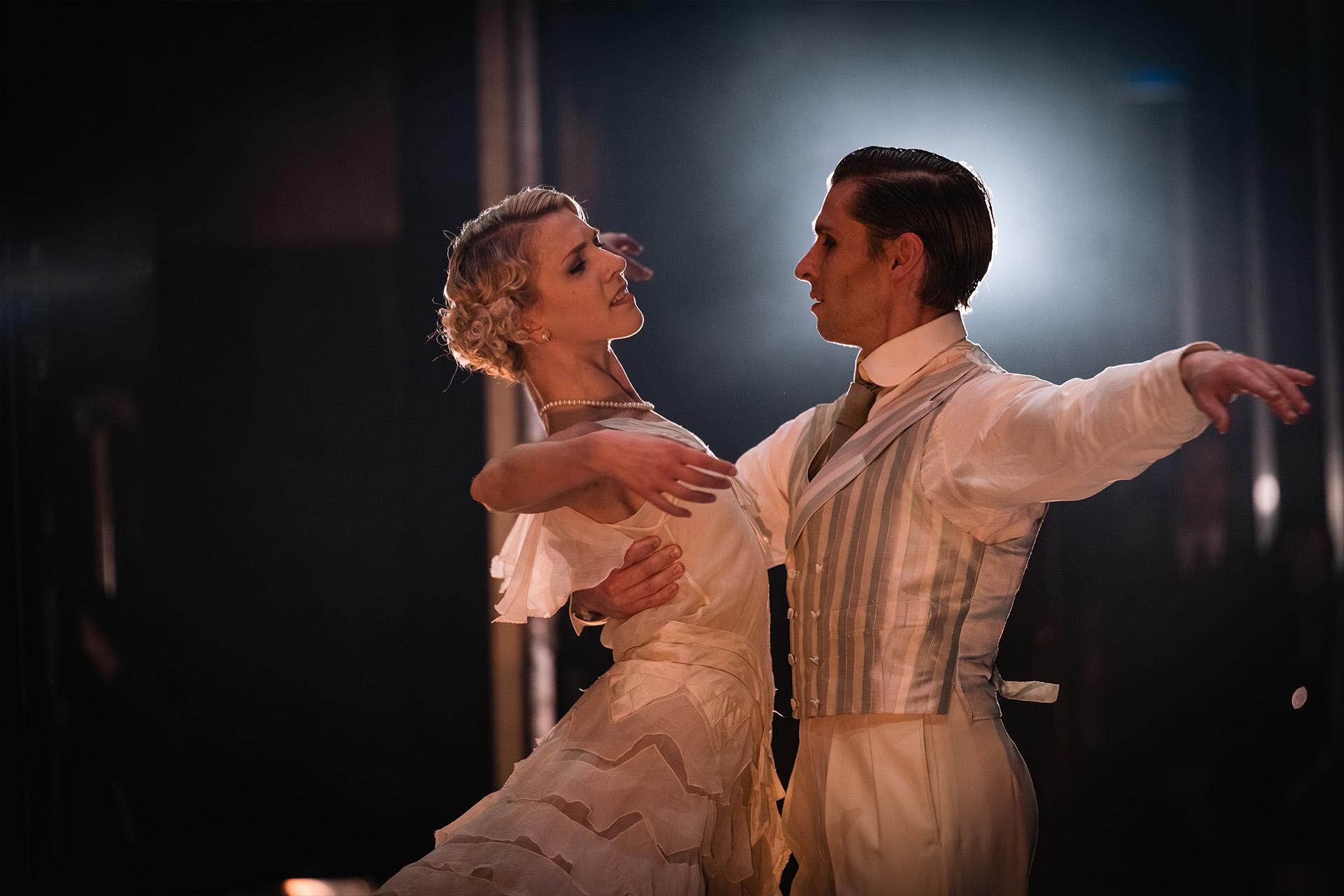 The Great Gatsby, production, 2022, Antoinette Brooks-Daw and Ashley Dixon. Photo Riku Ito Daisy being held by Jay while they look into one another's eyes with love
