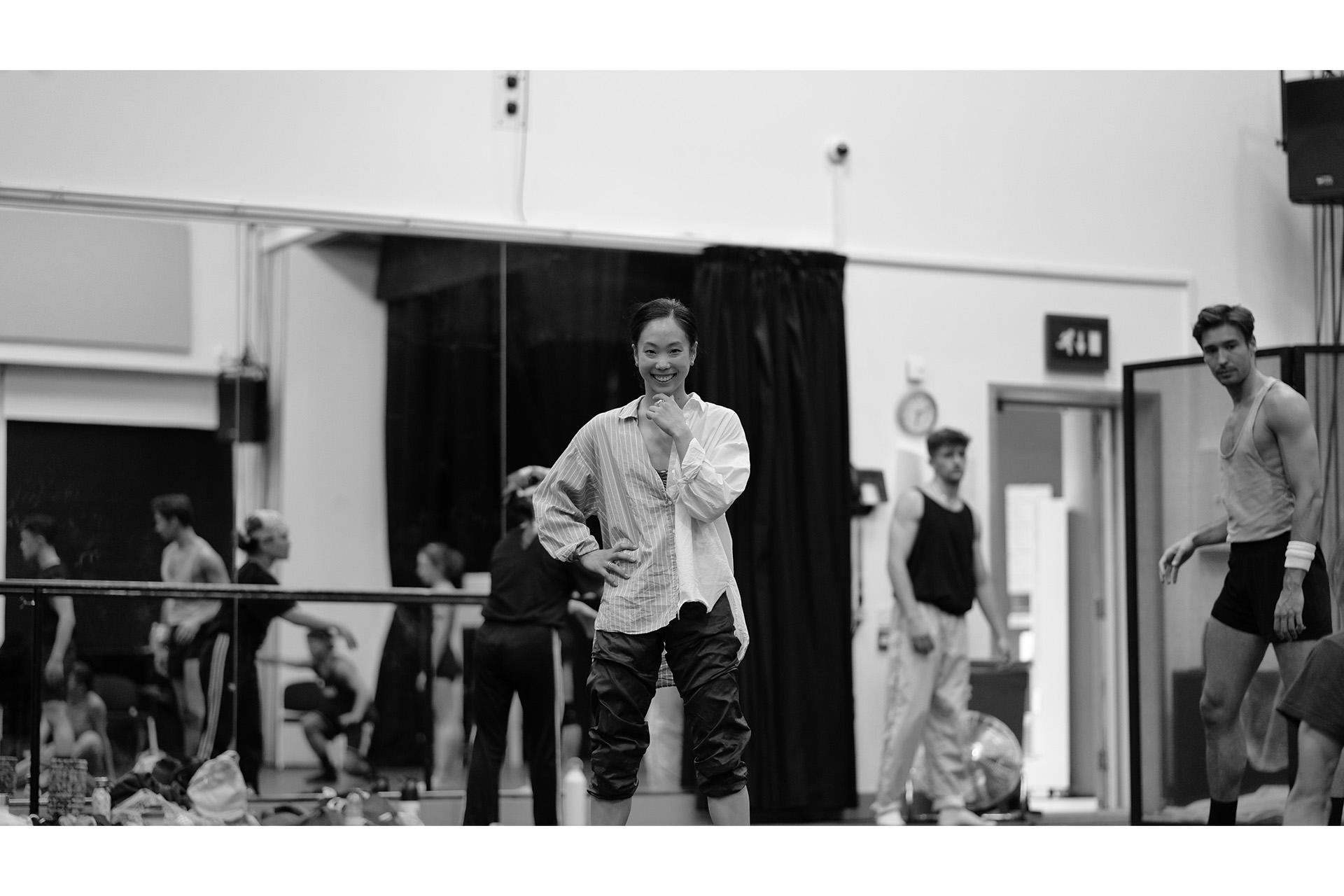 Black and white photo featuring a dancer smiling at the camera