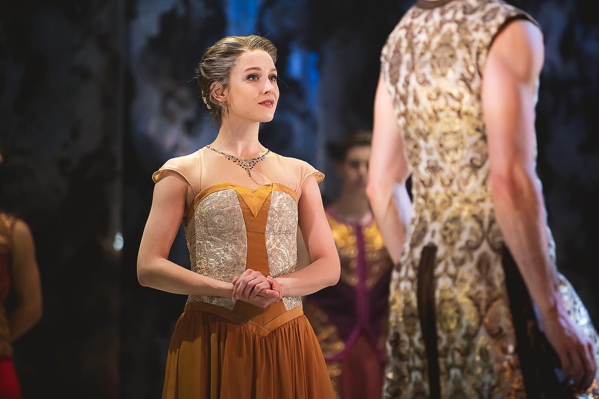Dancer looking regal as Prince Adair's mother, Brina, wearing a dress of autumnal colours
