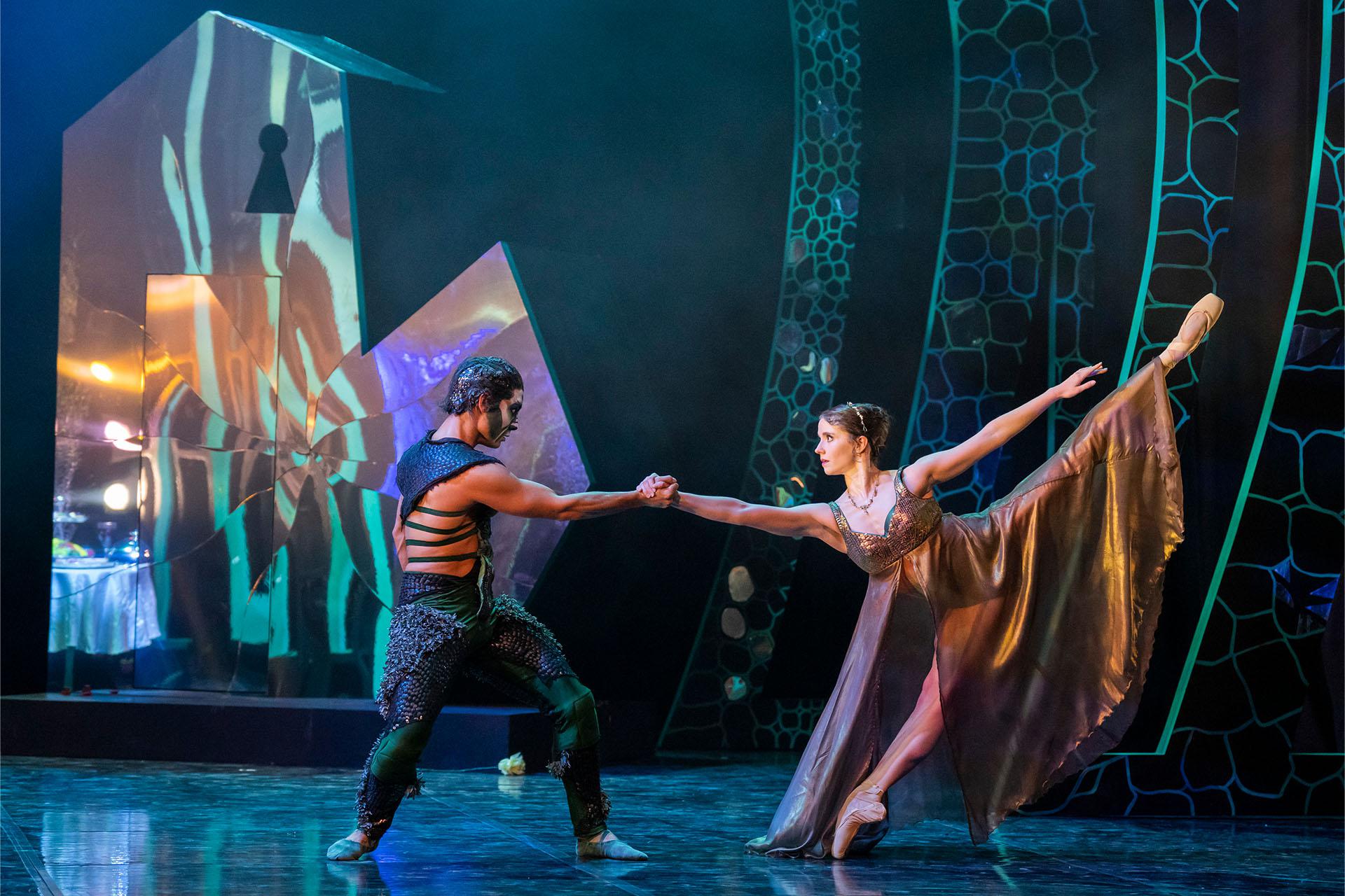 Beauty and the Beast, production, 2023, dancers Dominique Larose, and Kevin Poeung, photo Tristram Kenton The Beast and Beauty facing each other but pulling away while holding a hand.