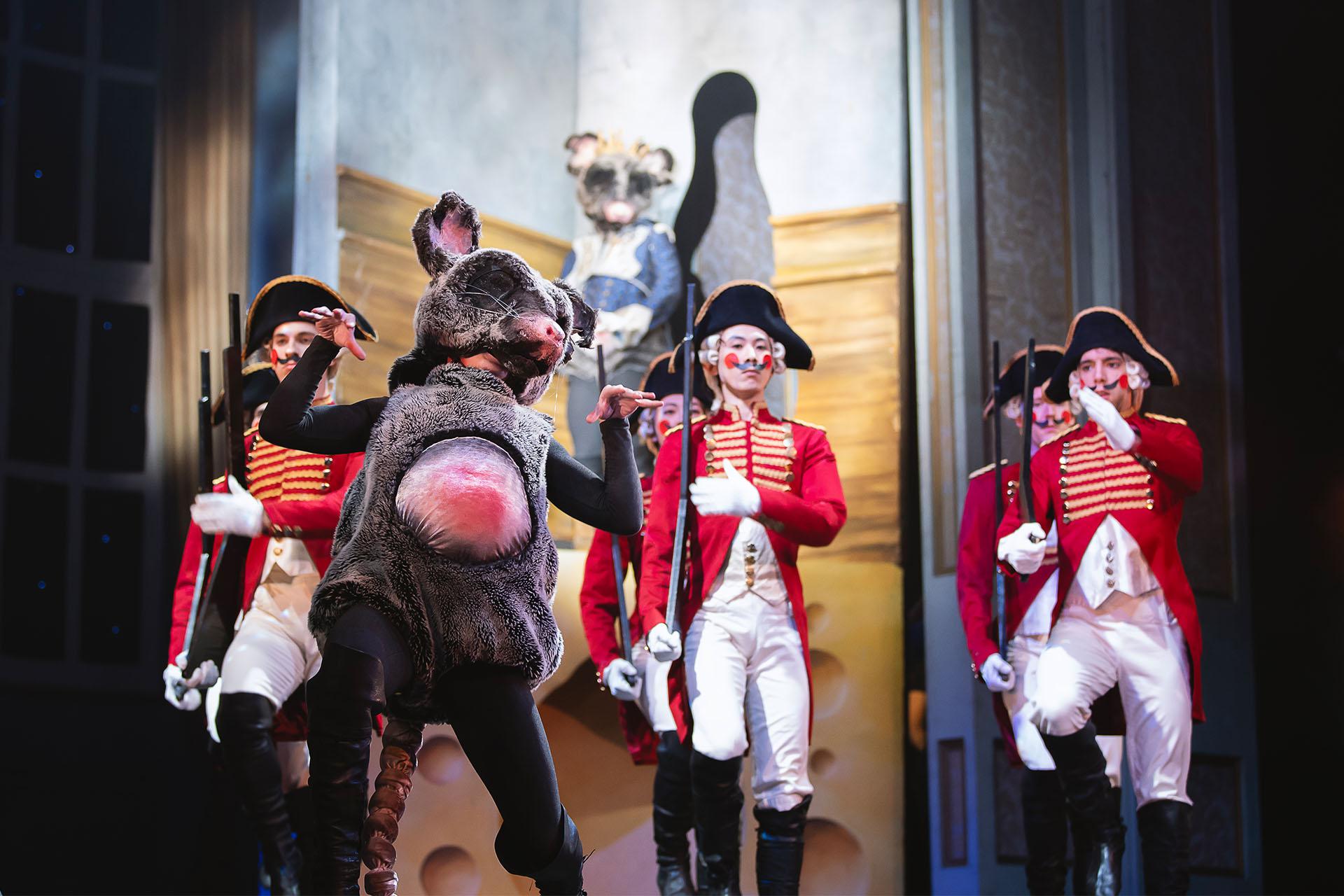 The Mouse King poses comically while the forces of Toy Soldiers gather behind him