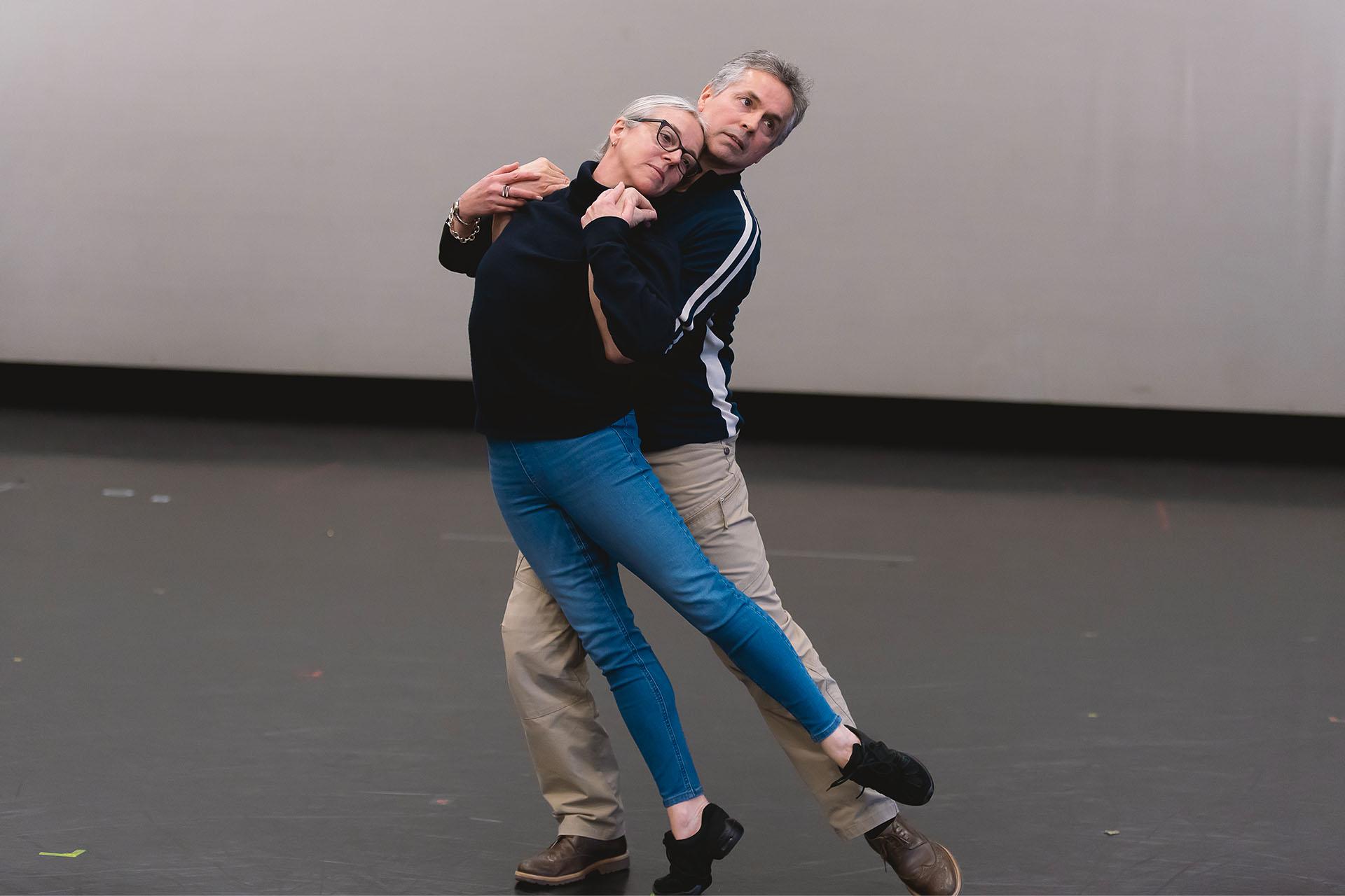 Jayne Regan Pink and William Walker, the original Romeo & Juliet in this production, demonstrate choreography to dancers unseen in the image