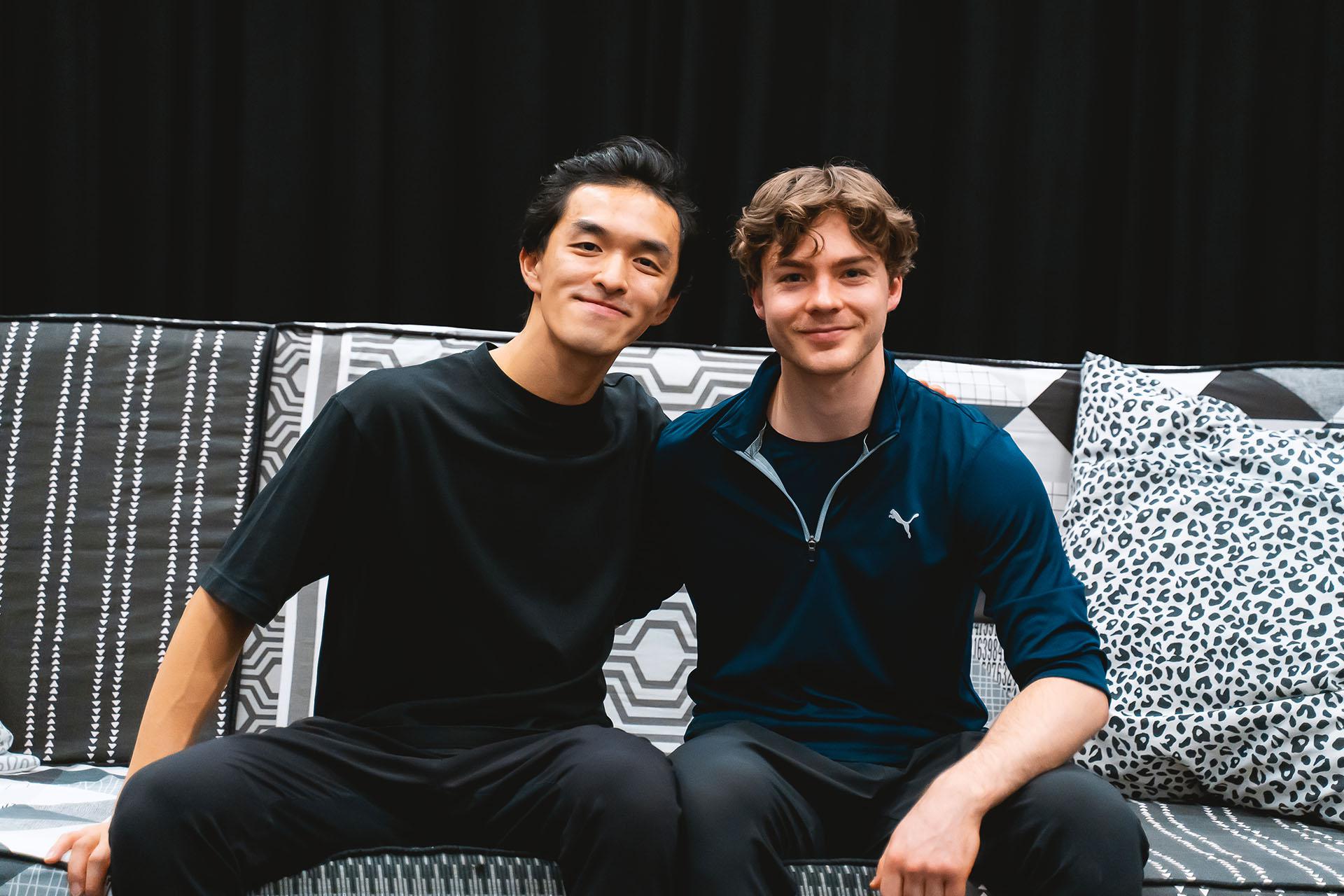 The two choreographers of Hansel & Gretel, George Liang and Harris Beattie, sat on the sofa that features in the ballet, both smiling directly at the camera