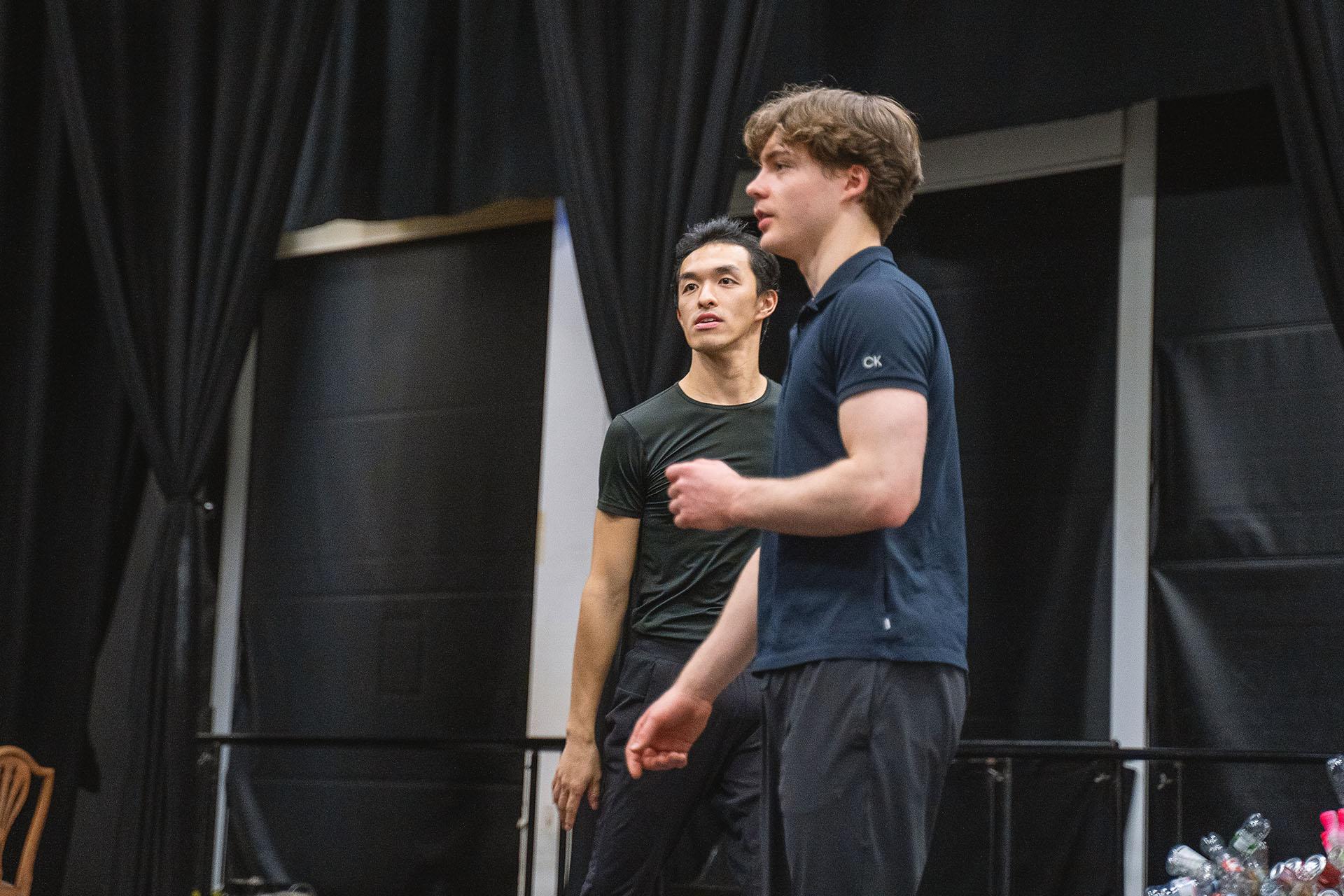 A low angle shot of the two choreographers of Hansel & Gretel giving instruction in the rehearsal rookm