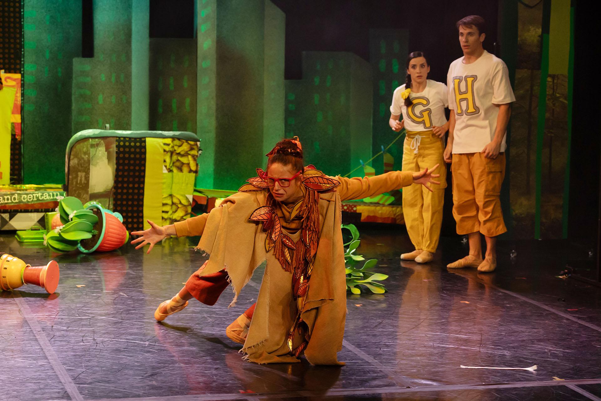 Hansel and Gretel stand in one corner beside upturned plant pots. The Lady of the Forest looks upset.