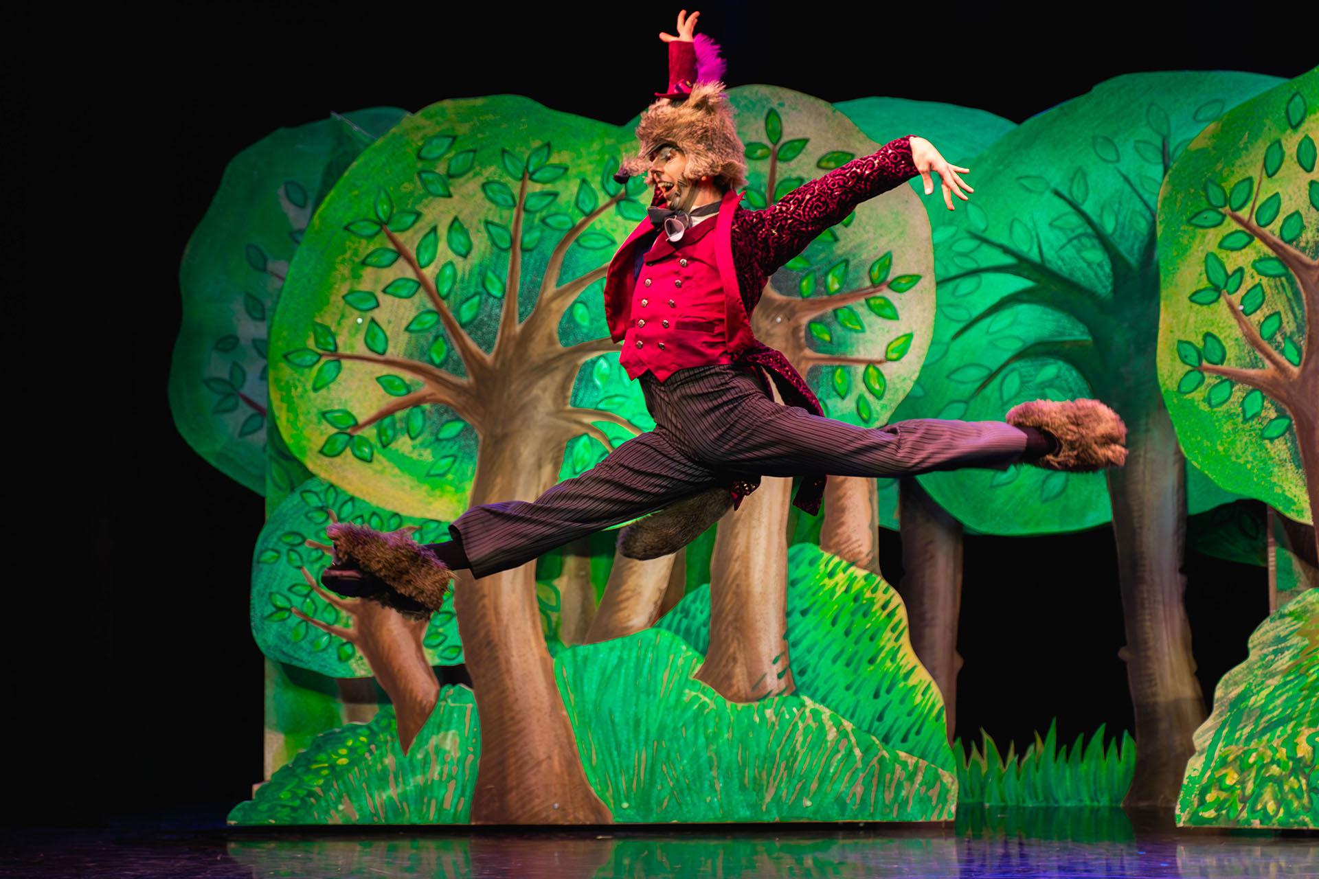 Little Red Riding Hood, production, 2025, dancer Albert González Orts. Photo Emily Nuttall The wolf, dressed in his red waistcoat, velvet jack and high trousers leaps high in a grand jete