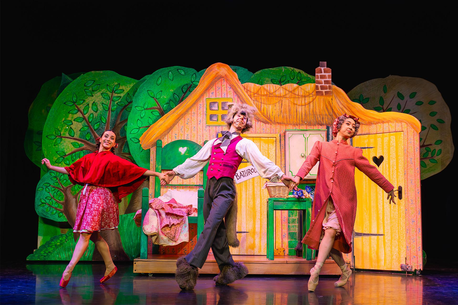 Little Red Riding Hood, production, 2025, dancers Julie Nunès, Albert González Orts and Kaho Masumoto. Photo Emily Nuttall Little Red, her grand-mother and the wolf all dance together, happily and hand-in-hand