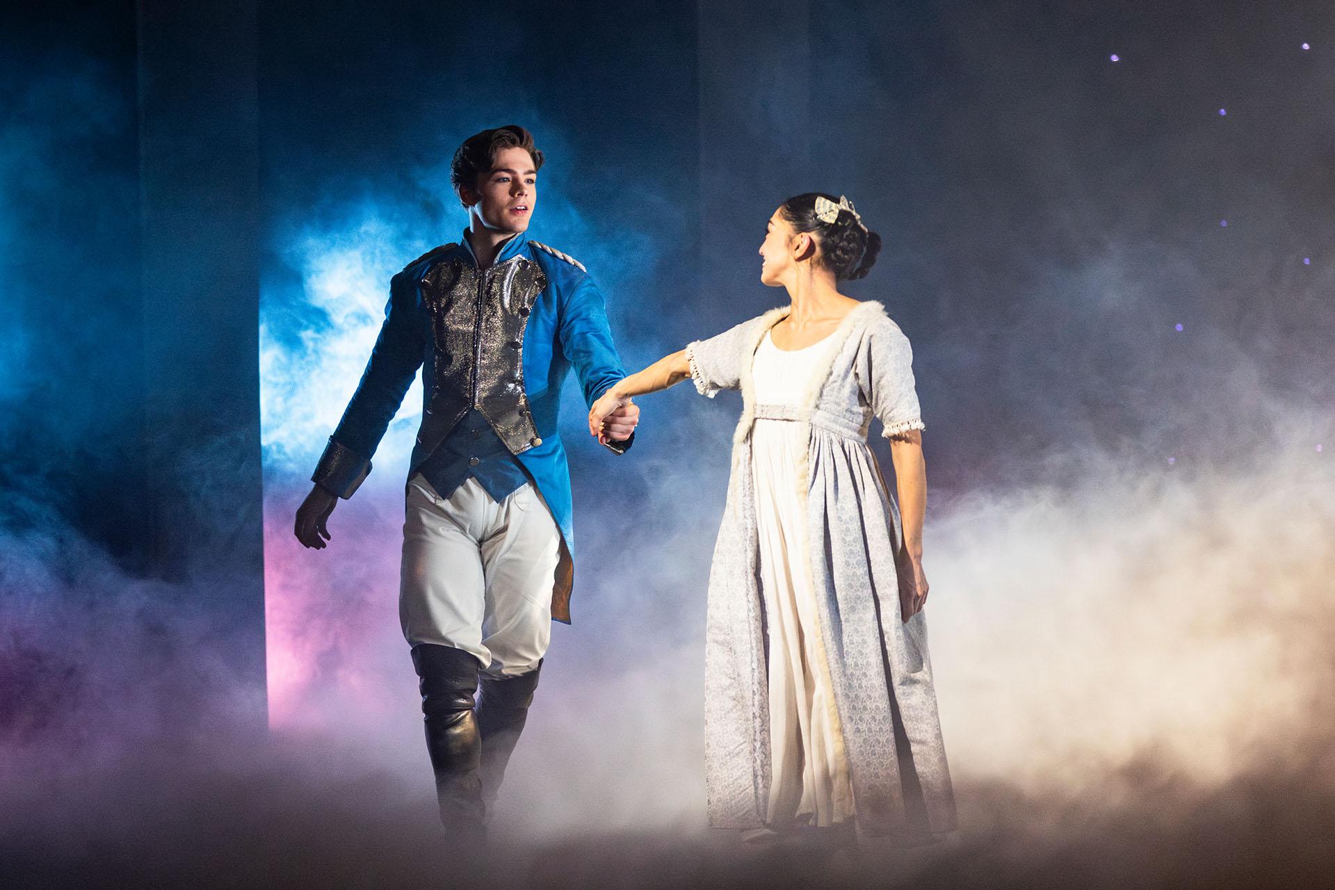 Clara in her which dress reaches for The Prince while they are surrounded by a magical mist