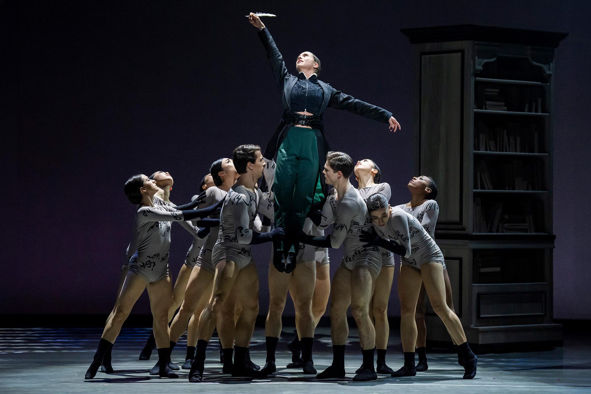 Anne Lister lifted by her words (represented by eleven dancers) and in turn raising a quill