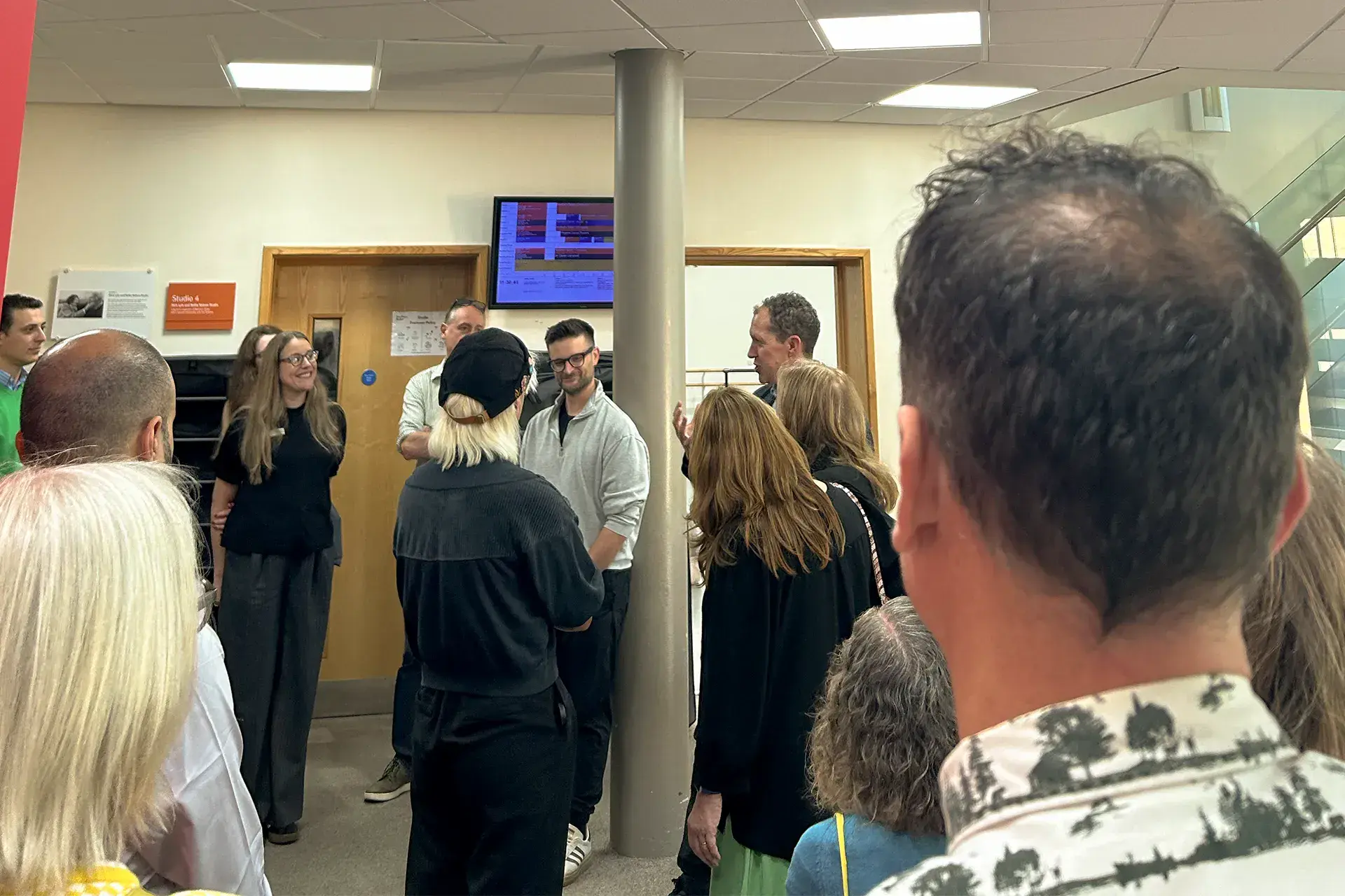 Group of people gathered outside of a dance studio discussing what happens with a teacher