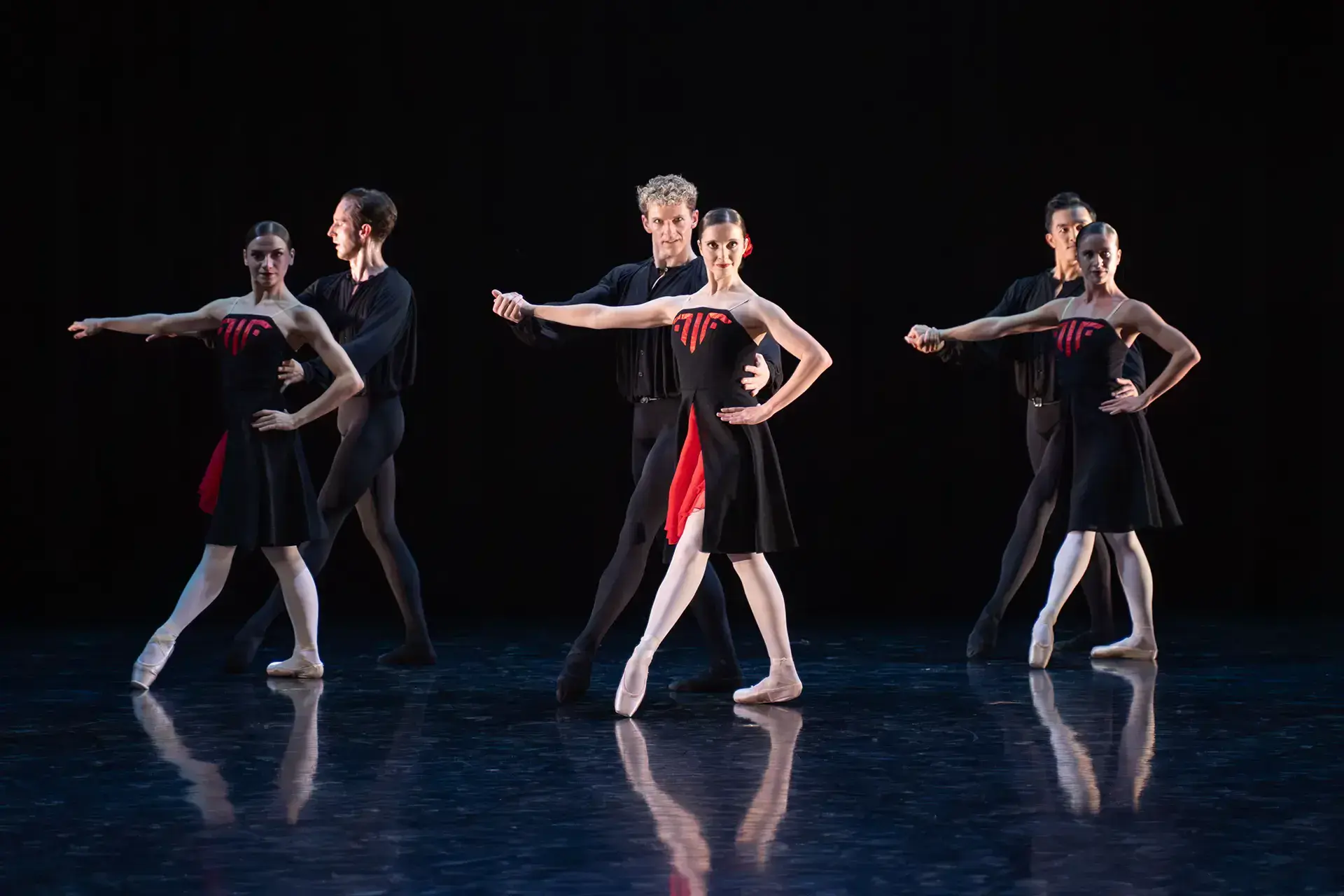 Three pair of dancers, each couple with a woman in from and a man behind both holding one arm out horizontally