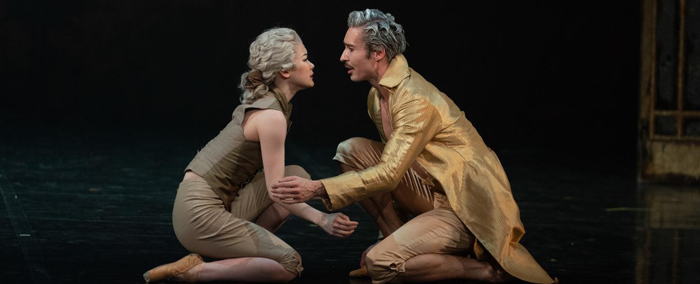 Casanova dressed in a golden coat looks into lovingly the eyes of Henriette