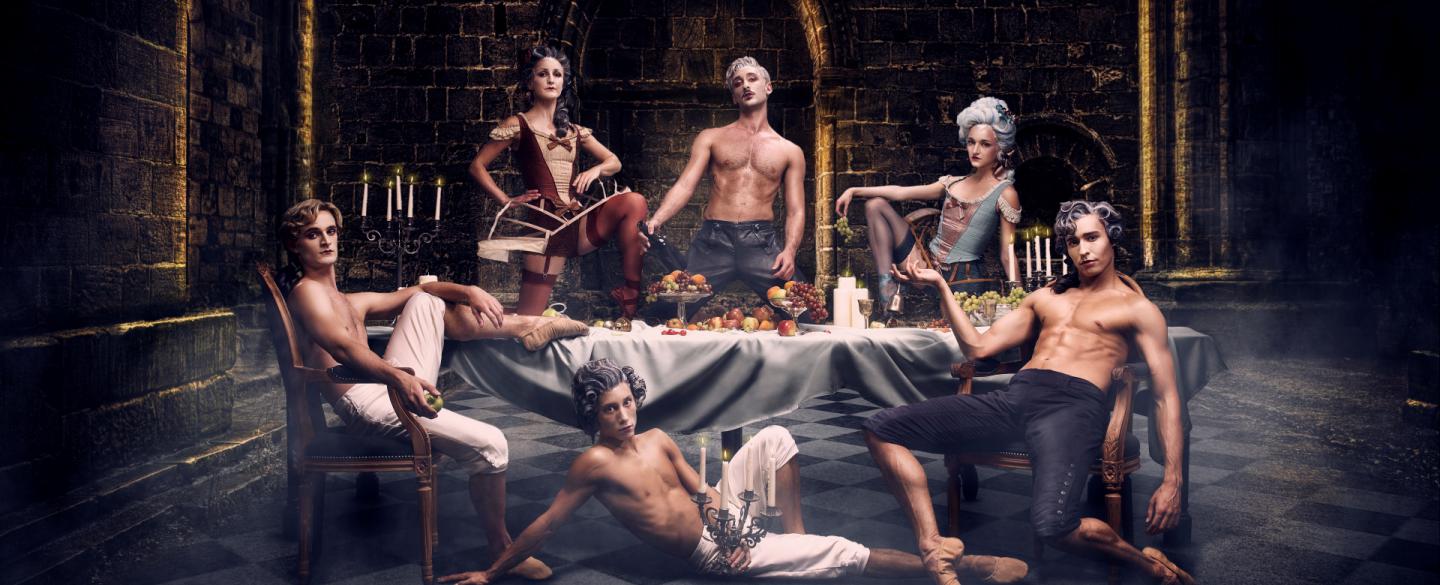 A group of dancers sit around a table, relaxing after a party