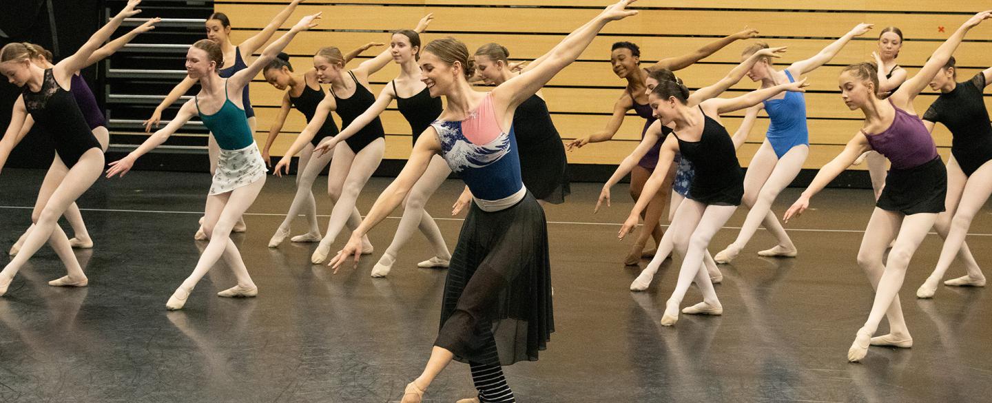 Charlotte Tonkinson in a ballet pose with academy students