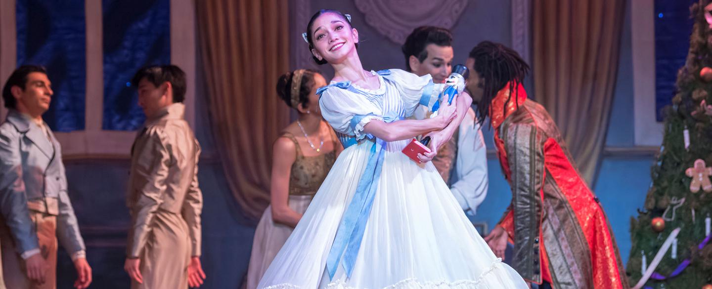 Female dancer in the Nutcracker holding a Nutcracker doll