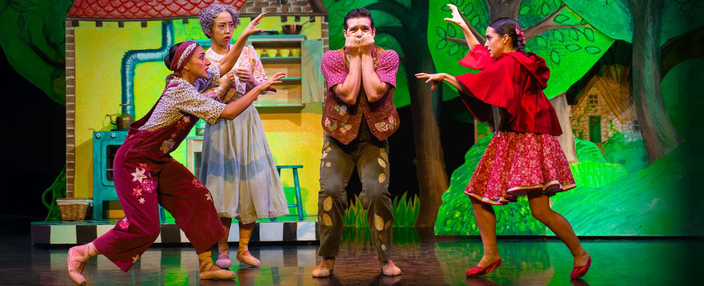 Little Red's family: father, mother, grandmother and Little Red act out the scary wolf to father who is quivering in fright