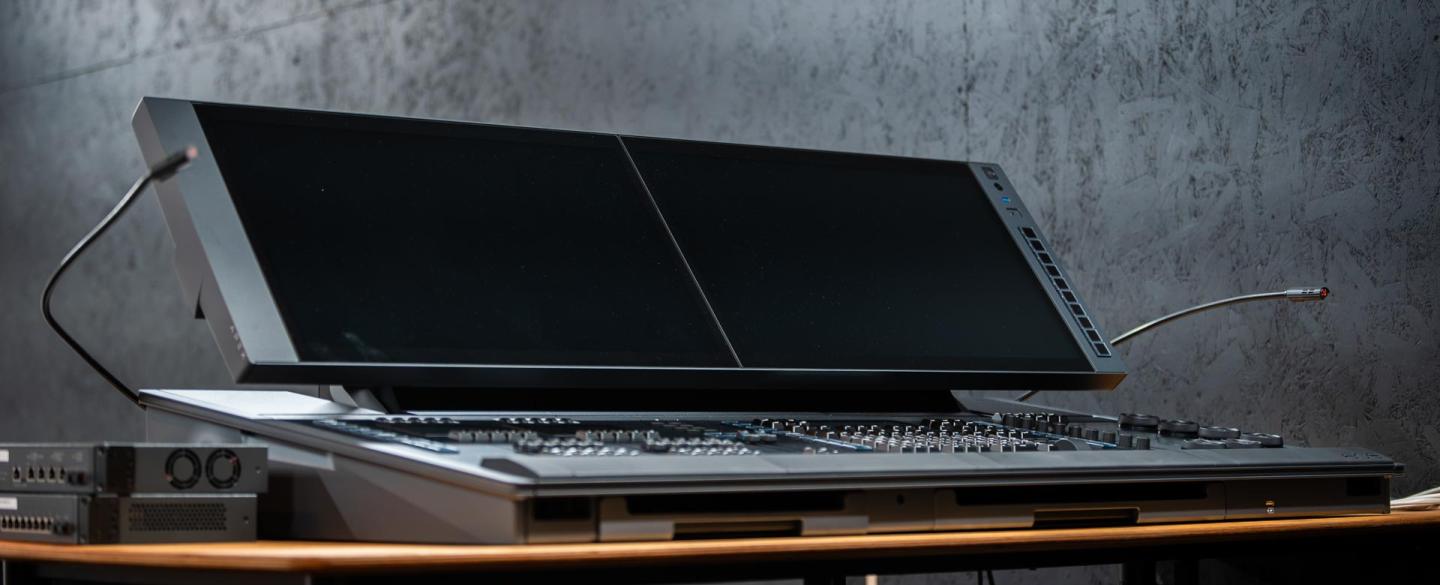 A new black lighting desk stood on a table with a grey background