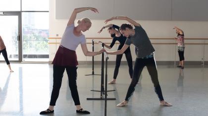 Dancers stretching at the barre in the Academy's adult class. Photo Kathie Tiffany.