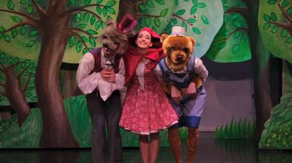 Little Red hugs Wolf and Bear after BEar agrees to sell Wolf some of his honey