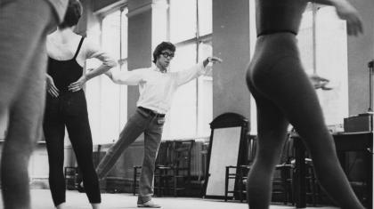 Laverne Meyer demonstrates a dance move to a full rehearsal room