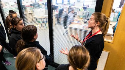 A group of students on a tour of Northern Ballet's offices, led by a Dance Education Officer.