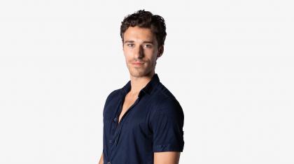 Headshot of male dancer in navy shirt