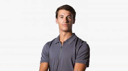 Headshot of a male dancer in a navy polo shirt
