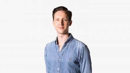 Headshot of a male dancer in a denim shirt