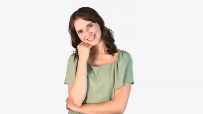 Headshot of a female dancer in a green top