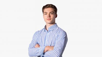 Headshot of a male dancer in a blue striped shirt